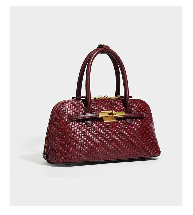 Structured woven-embossed leather-look satchel with dual rolled top handles, gold-tone turn-lock closure, and detachable