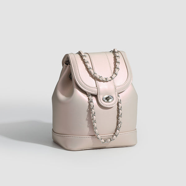 Small pearl-gloss backpack handbag with woven silver chain straps and turn-lock flap closure, detail view 3
