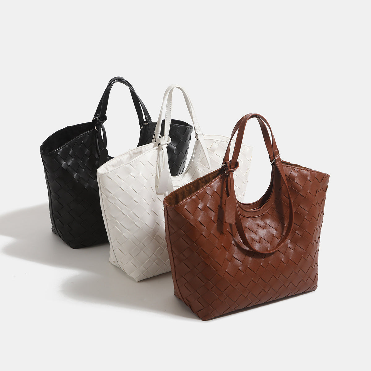 Large woven leather-look tote bag with open top and dual shoulder handles, detail view 2