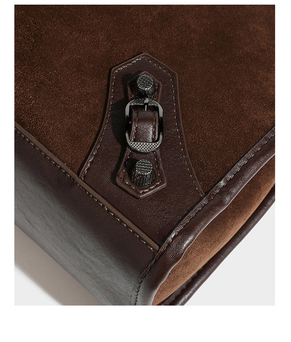 Large structured tote bag with matte suede-like body, smooth leather-look trim, front zip pocket, stud hardware, and
