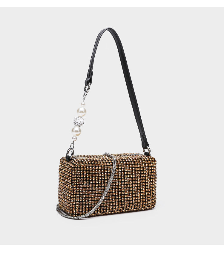 Small rectangular all-over rhinestone crossbody bag with pearl bead zipper pull and detachable silver chain strap, detail