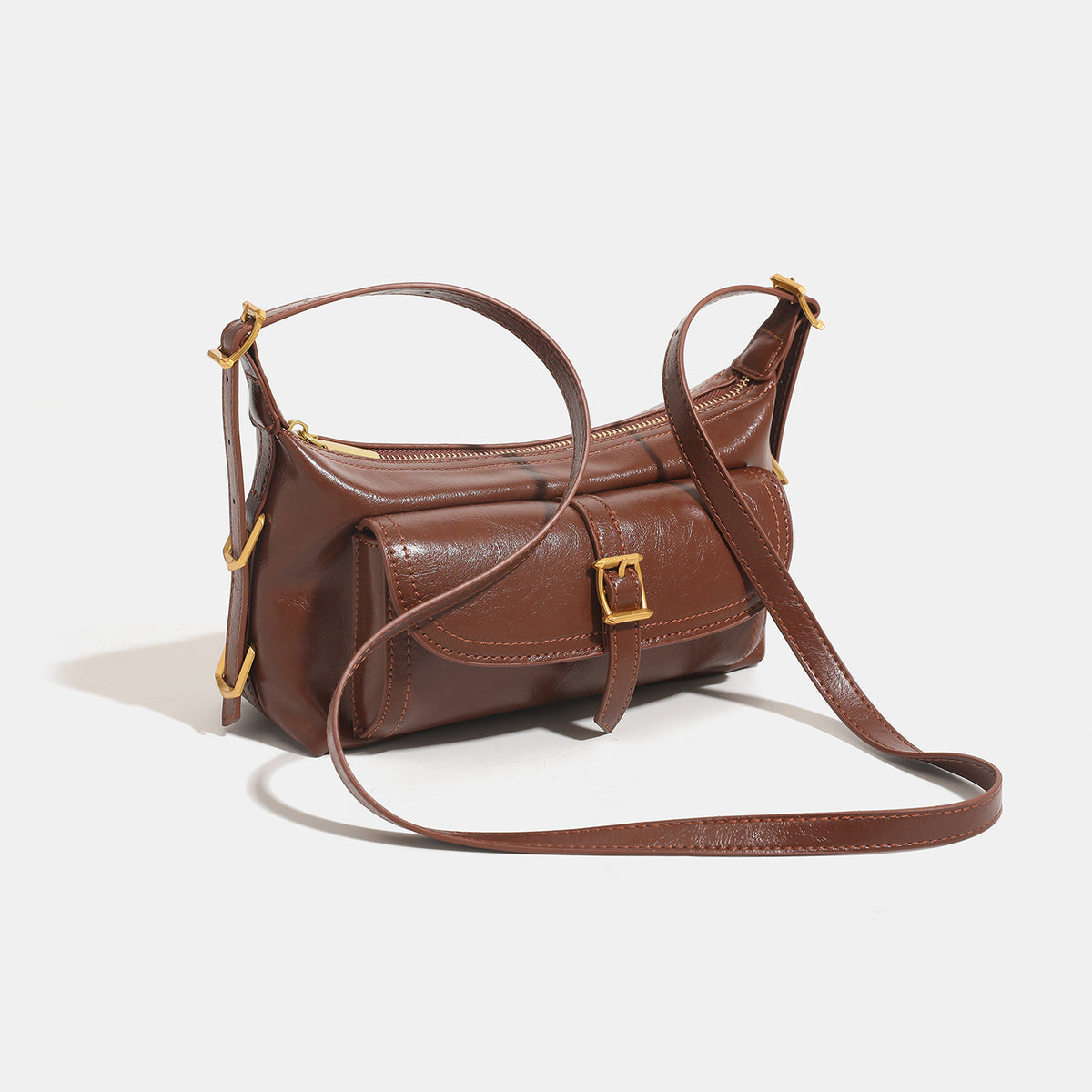 Compact glossy oil-wax leather-look shoulder bag with front buckle flap pocket and gold-tone hardware, detail view 3