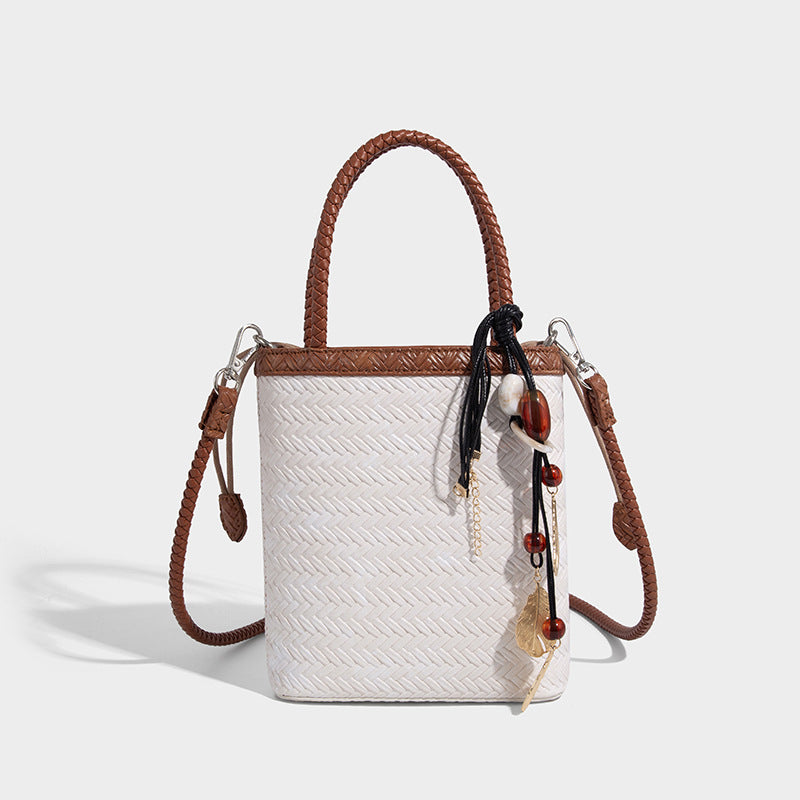 Small structured woven-texture tote bag with braided top handles and drawstring inner pouch, detail view 12