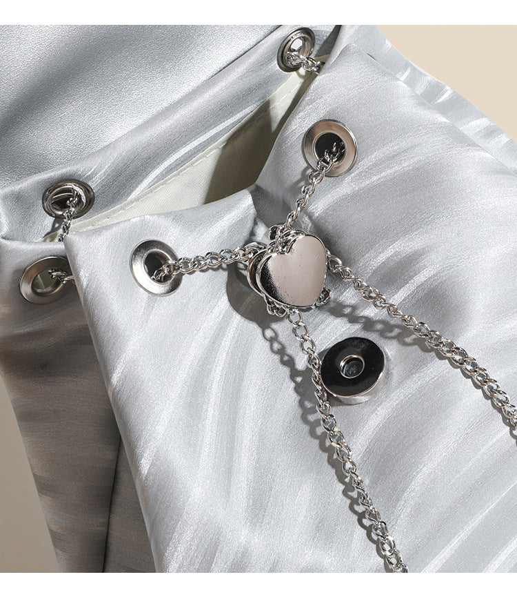 Compact ripple-embossed leather-look backpack handbag with silver butterfly clasp and chain straps, detail view 11