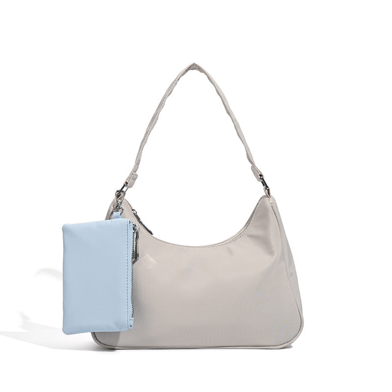 Curved hobo shoulder bag with detachable zip pouch in matte-satin finish with silver-tone hardware, detail view 5