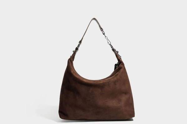 Slouchy suede-finish hobo shoulder bag with dark hardware, exterior zip pocket, tassel ties, and detachable crossbody strap