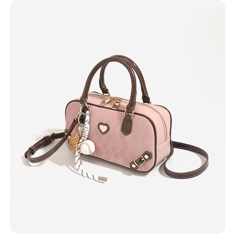 Small structured blush pink quilted diamond Boston barrel bag with brown leather-look trim, double top handles, heart accent