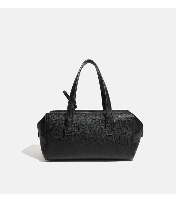 Structured pebbled leather-look top-zip barrel bag with dual handles, detachable shoulder strap, and attached croc-pattern