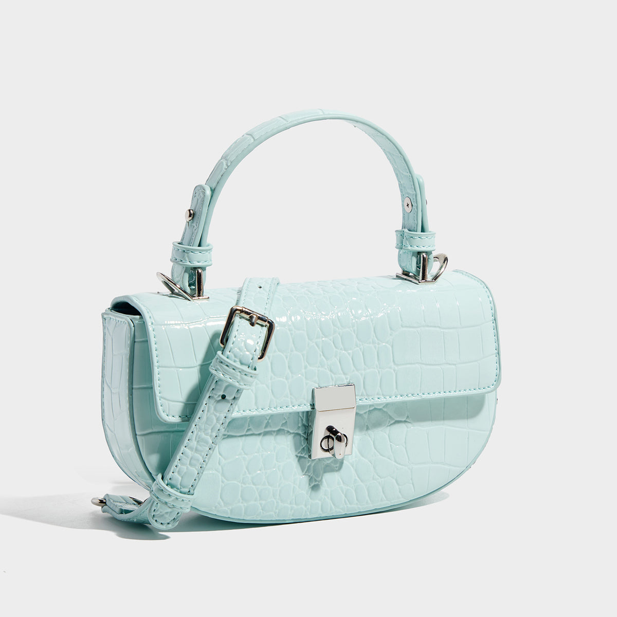 Glossy croc-embossed mini saddle bag with silver-tone turn-lock clasp and short top handle, detail view 3