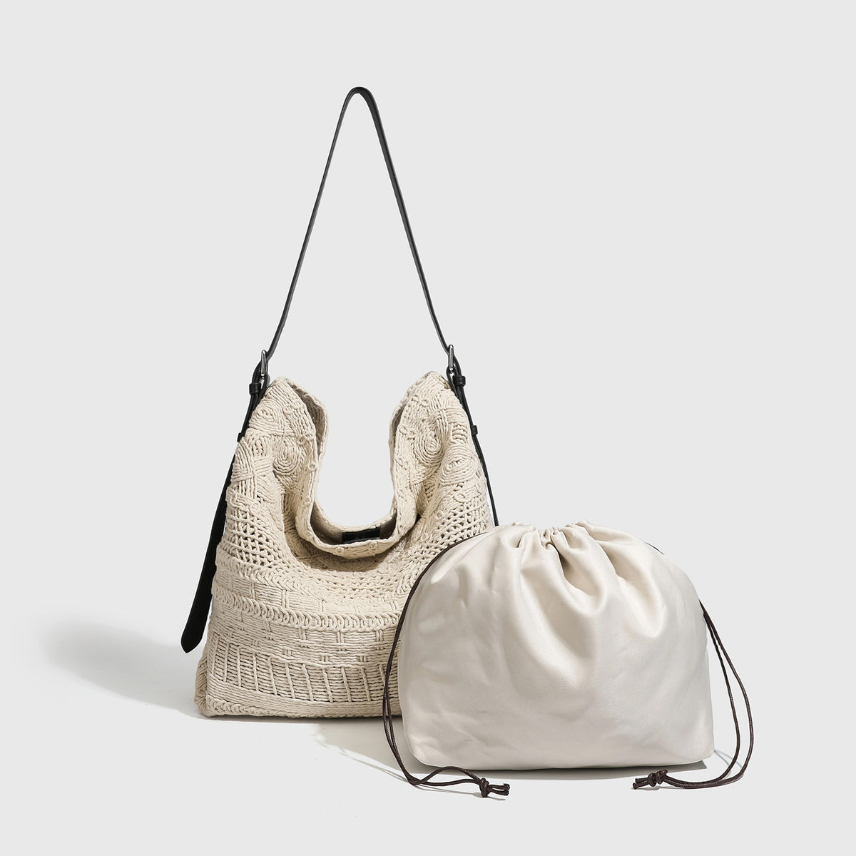 Cream woven rope-cord hobo bag with black adjustable leather-look strap and matching cream drawstring pouch, detail view 3
