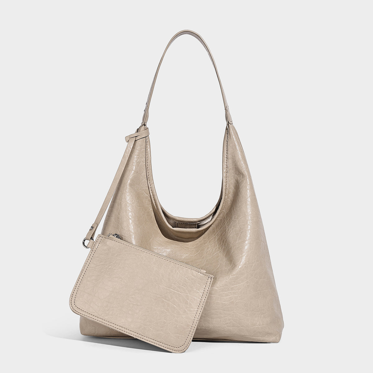 Slouchy hobo shoulder bag in pale yellow glossy pebbled leather-look finish with single shoulder strap and detachable front