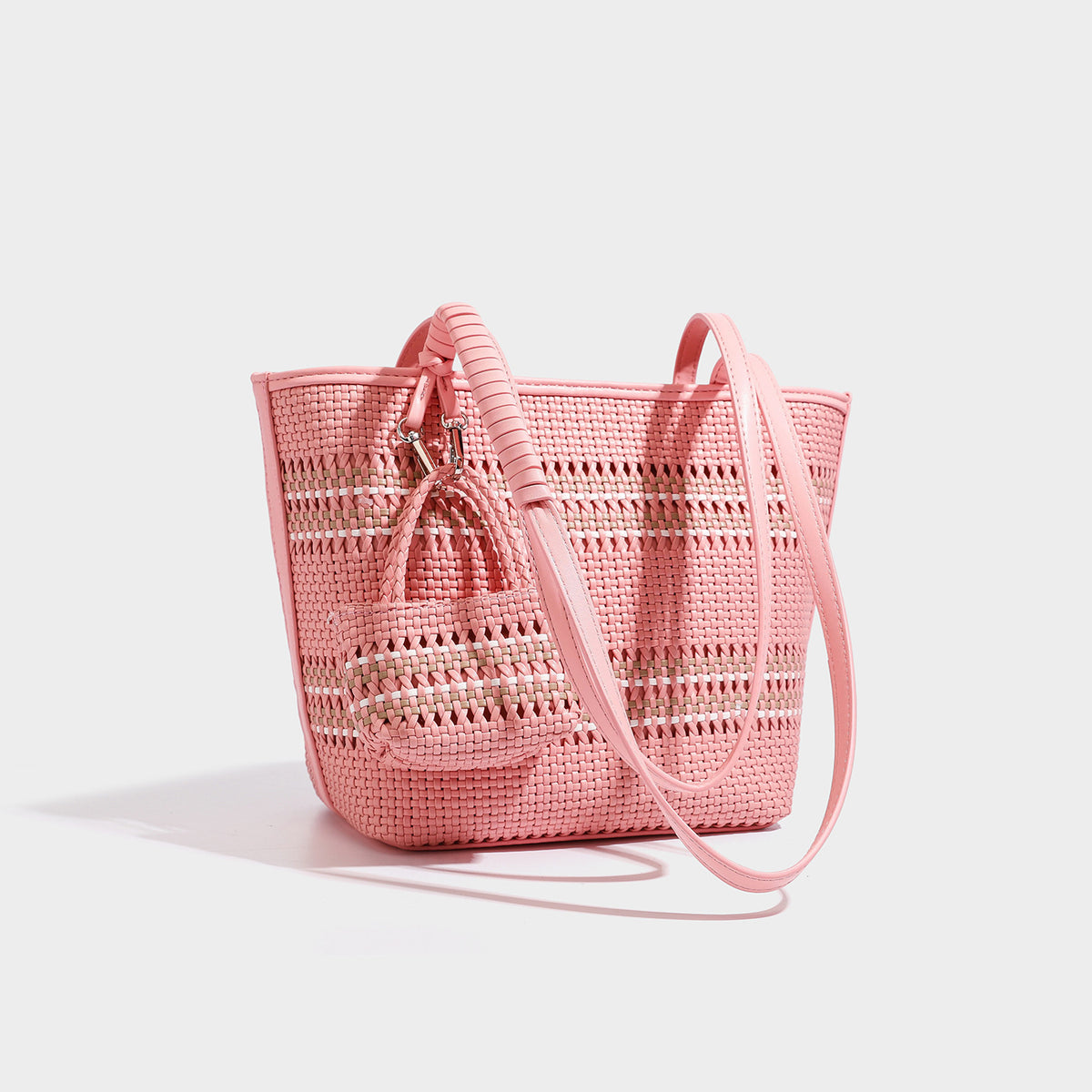 Large structured woven tote bag with striped basket-weave finish, long shoulder straps, and detachable mini pouch charm