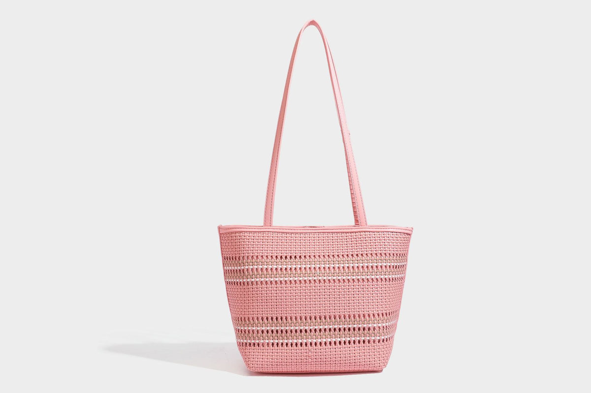 Large structured woven tote bag with striped basket-weave finish, long shoulder straps, and detachable mini pouch charm