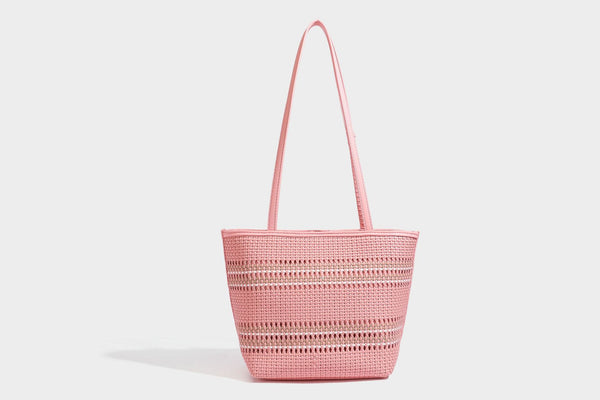 Large structured woven tote bag with striped basket-weave finish, long shoulder straps, and detachable mini pouch charm