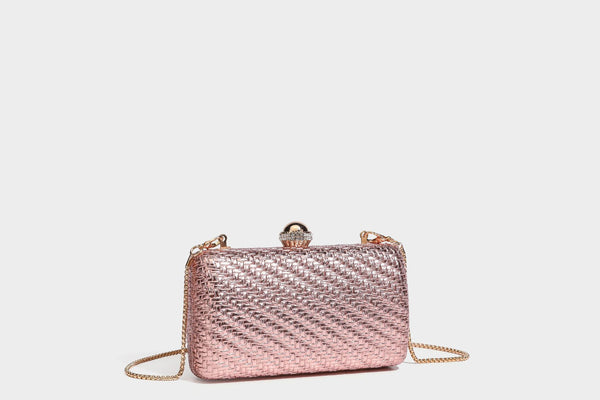 Small structured metallic woven-texture box clutch bag with jeweled kiss-lock dome clasp and slim gold chain strap, detail