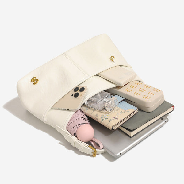 Relaxed leather-look shoulder tote bag in cream white with front exterior pocket, gold-tone ring hardware, and adjustable