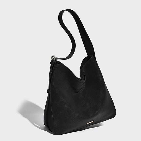 Large slouchy hobo shoulder bag in matte leather-look finish with adjustable strap and gold-tone bar hardware, front view