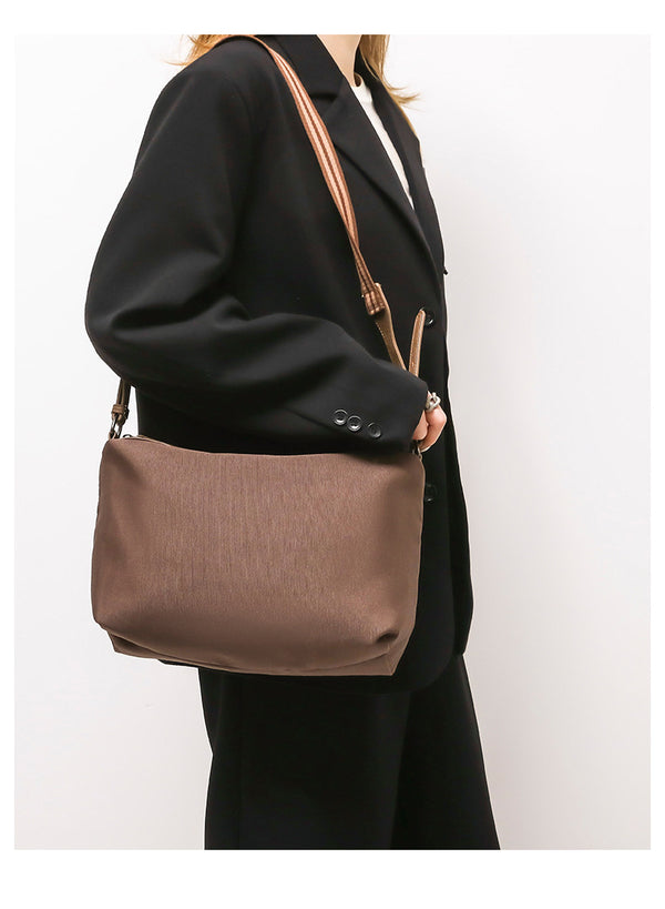 Retro structured matte leather-look tote bag in camel with front flap pocket, tassel pull, and double top handles, detail