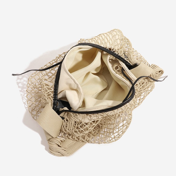 Crescent-shaped open-weave mesh shoulder bag with black drawstring cord tie and long padded strap, detail view 3