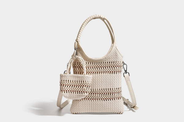 Color-block woven tote bag with rounded leather-look handles, detachable crossbody strap, and matching mini clip-on pouch in