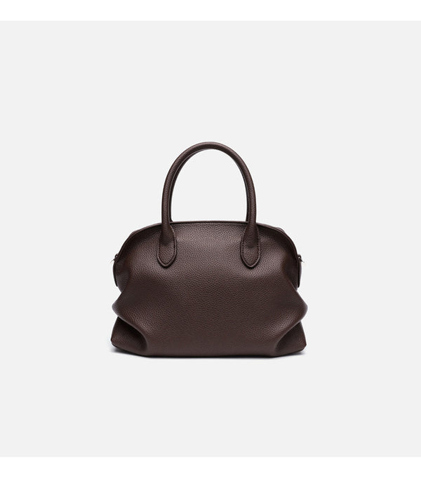 Rounded dome shell handbag in pebbled leather-look finish with twin top handles, zip closure, decorative horse charm, and