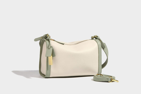 Structured two-tone shoulder bag with pebbled leather-look finish, contrast trim, top zip closure, and gold-tone hardware