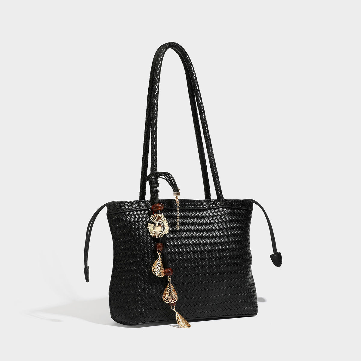 Structured woven leather-look tote bag in dark brown with long shoulder straps, side drawstring ties, and gold filigree