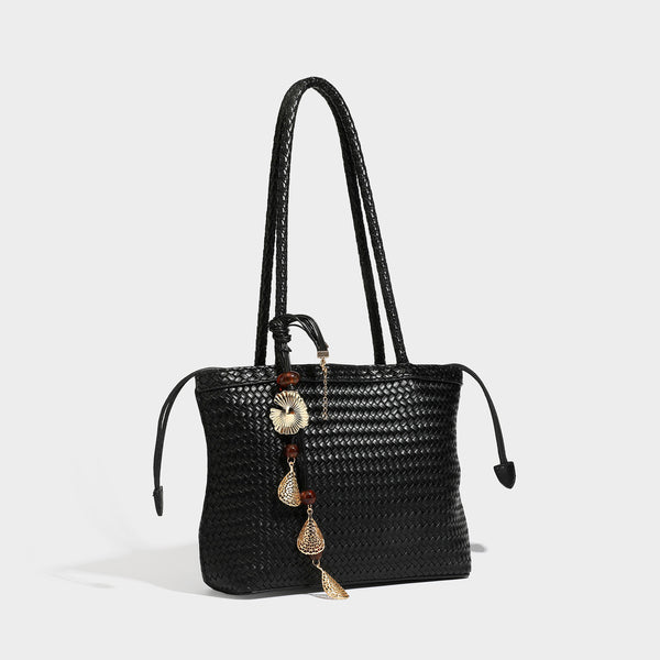 Structured woven leather-look tote bag in dark brown with long shoulder straps, side drawstring ties, and gold filigree