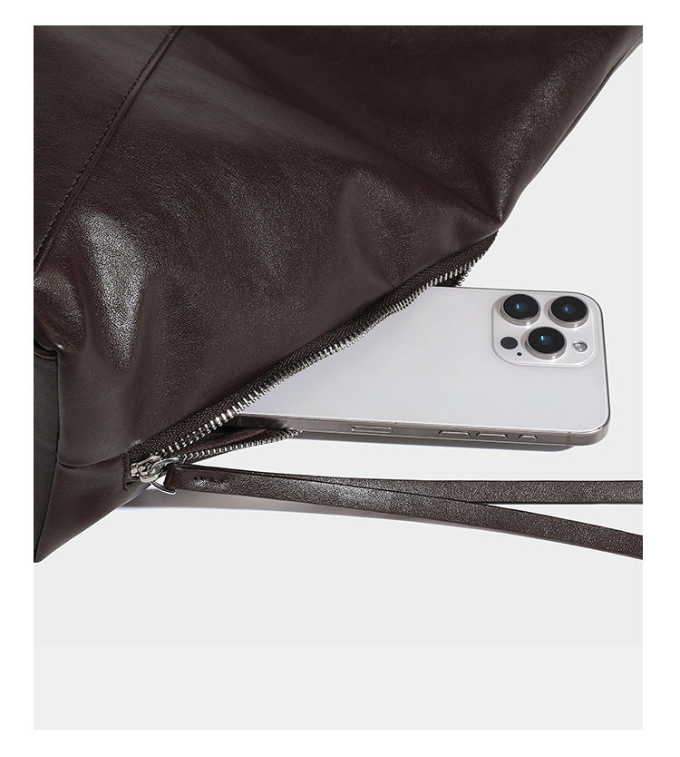 Large slouchy hobo shoulder bag with braided top handle, smooth glossy leather-look finish, and silver-tone ring hardware