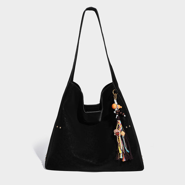 Oversized trapezoid tote bag with matte leather-look finish, gold-tone rivets, and long shoulder strap, detail view 6