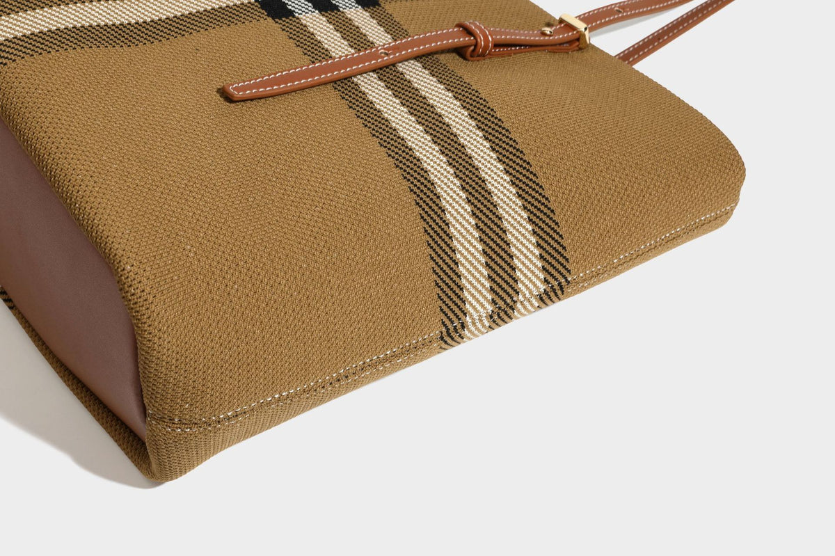 Large structured plaid check tote bag with smooth tan leather-look shoulder straps, attached front zip pouch, and gold-tone
