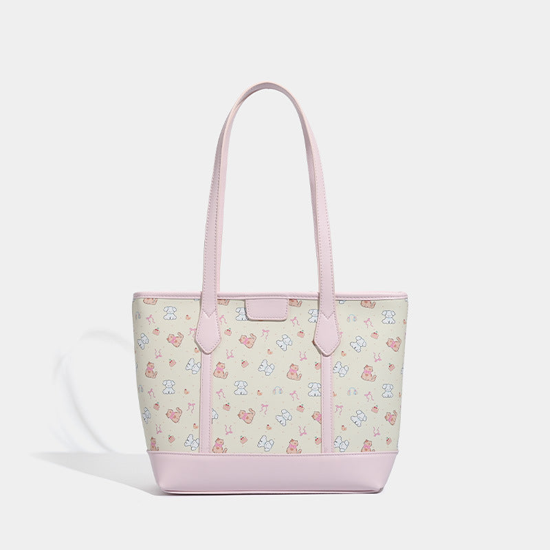 Große, strukturierte Tote-Bag mit Reißverschluss oben, Einsätzen mit pastellfarbenem Cartoon-Print, glattem Besatz in rosafarbener Lederoptik und zwei Schulterriemen