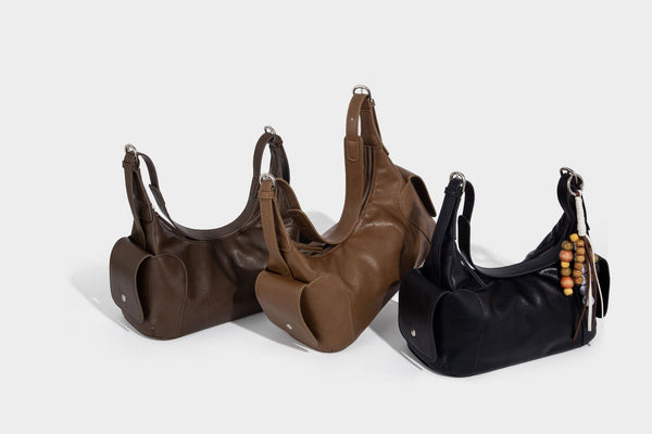 Soft pebbled leather-look hobo shoulder bag with zip top closure, side flap pockets, and silver-tone hardware, detail view 33
