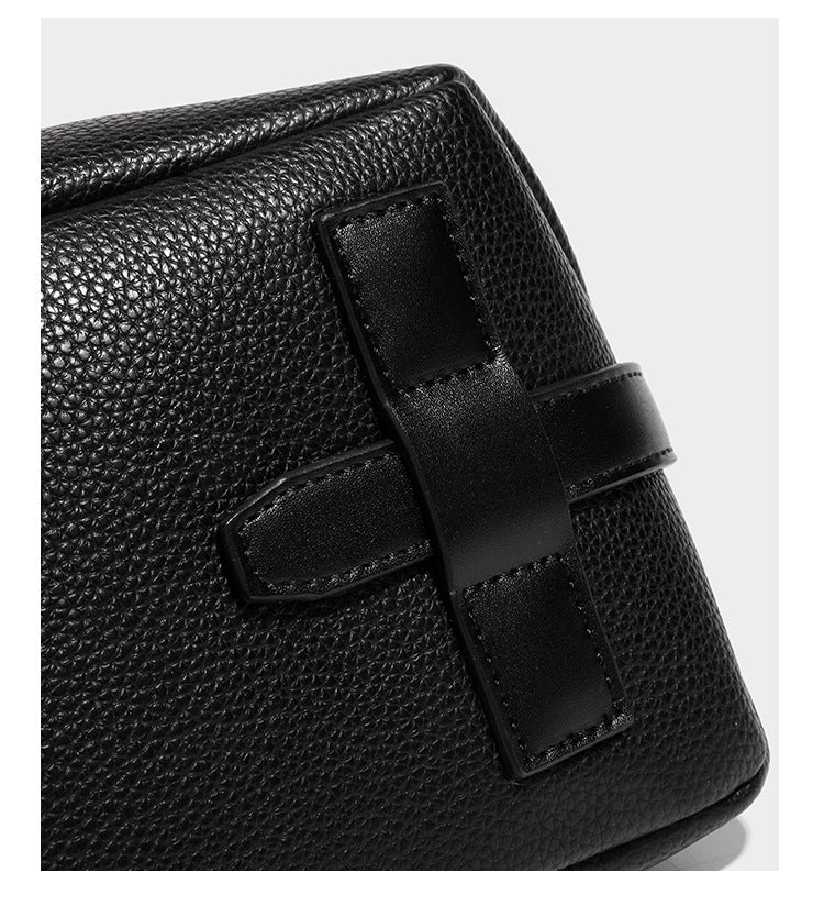 Slouchy hobo shoulder bag with pebbled leather-look finish, zip-top closure, gold-tone hardware, and hanging bead charm