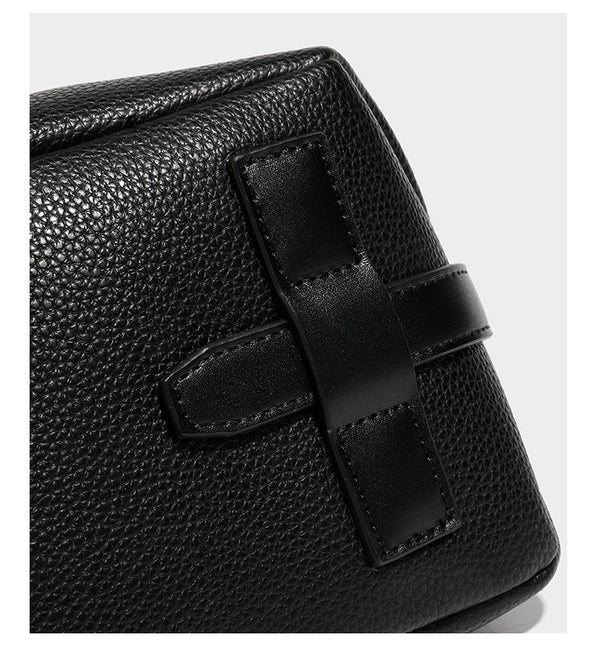 Slouchy hobo shoulder bag with pebbled leather-look finish, zip-top closure, gold-tone hardware, and hanging bead charm