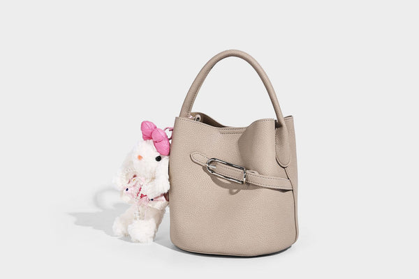 Mini pebbled leather-look bucket bag with front buckle strap, silver-tone hardware, top handle, and detachable shoulder