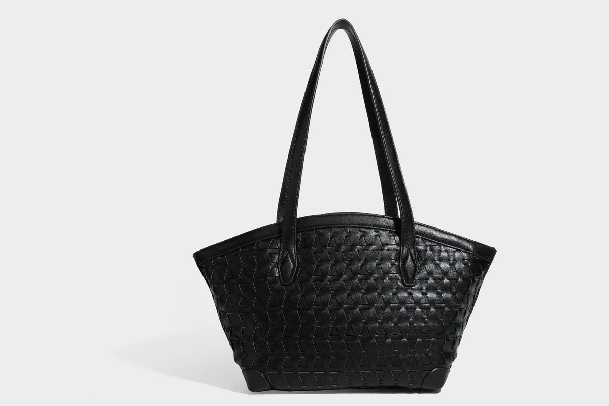 Large leather-look tote bag with geometric woven emboss, double shoulder straps, and round woven cord charm in brown, detail