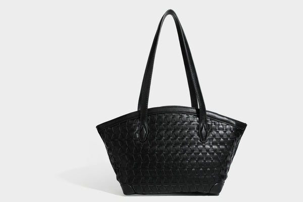 Large leather-look tote bag with geometric woven emboss, double shoulder straps, and round woven cord charm in brown, detail