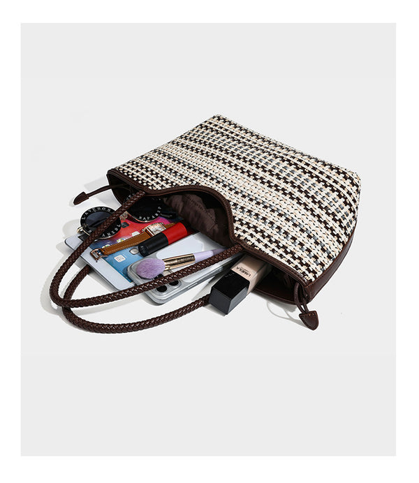 Large woven checker-pattern tote bag with dark braided shoulder straps, leather-look trim, and drawstring side ties, detail