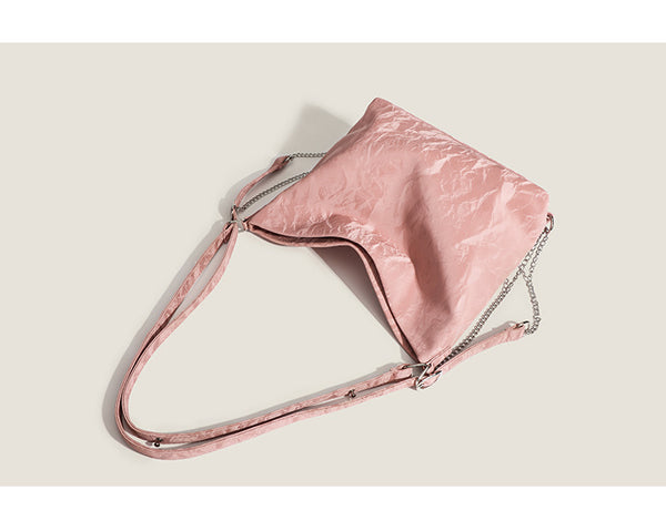 Blush pink slouchy hobo bag with crinkled sheen finish, silver-tone chain hardware, and adjustable shoulder strap, detail