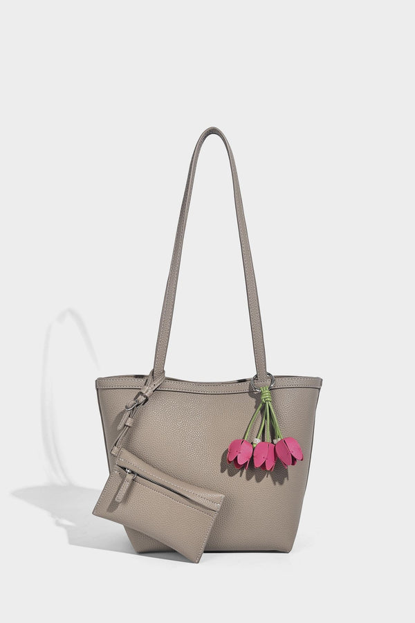 Structured pebbled leather-look tote bag in taupe with long shoulder strap, detachable zip pouch, and pink tulip flower