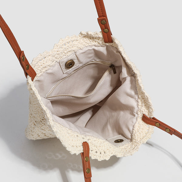 Woven crochet shoulder tote bag with scalloped floral top edge, tan leather-look straps, and antique gold rivets, detail view