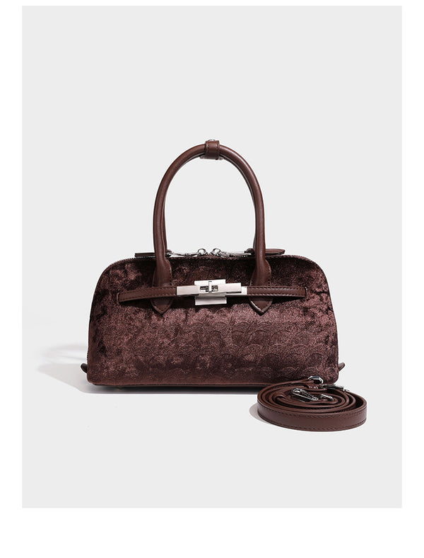 Small structured satchel bag in dark brown velvet-like textured finish with leather-look trim, silver-tone turn-lock bar