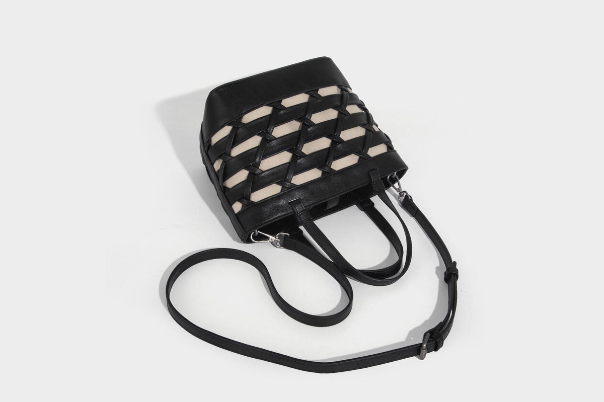 Structured woven lattice tote bag with cream lining, dual top handles, detachable crossbody strap, and silver-tone hardware