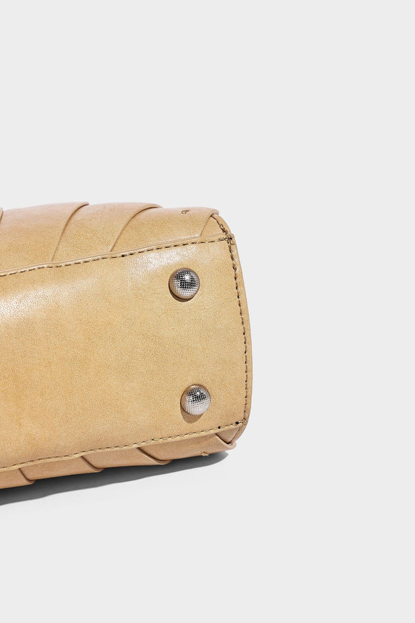 Structured dome satchel with fan-pleated leather-look exterior, dual top handles, and detachable shoulder strap, detail view