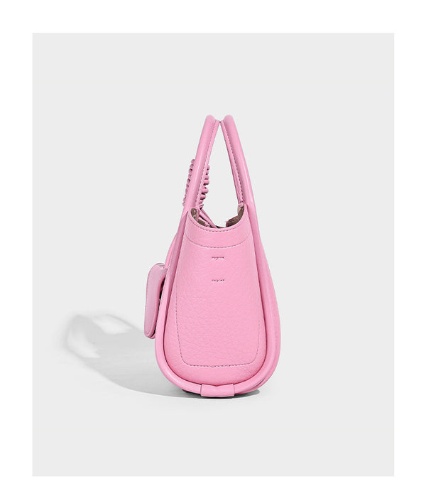 Structured mini tote bag in pebbled leather-look finish with knotted top handles, front flap pocket, and detachable shoulder