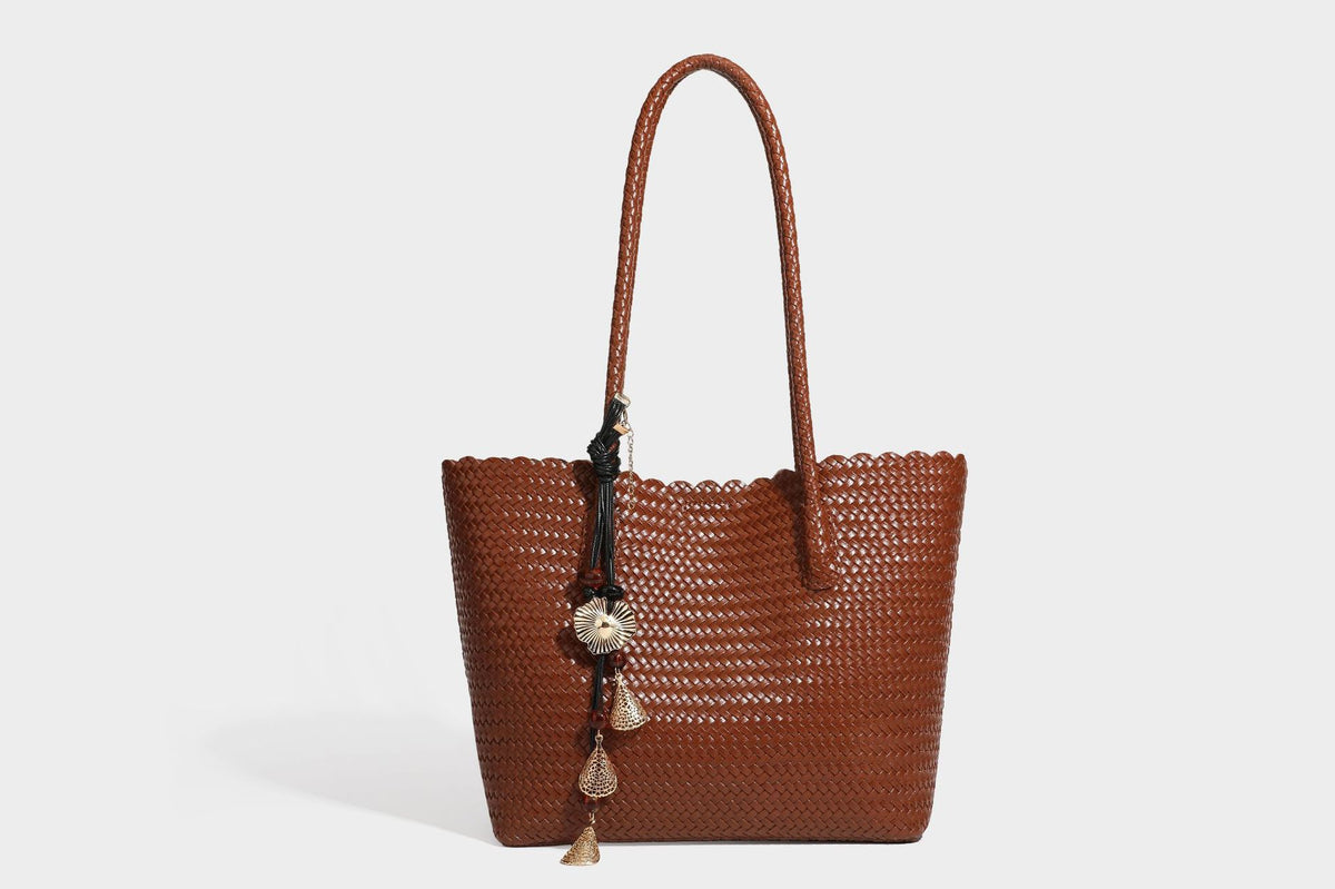 Large open-top woven leather-look tote bag in dark brown with scalloped edge, braided double shoulder straps, and decorative