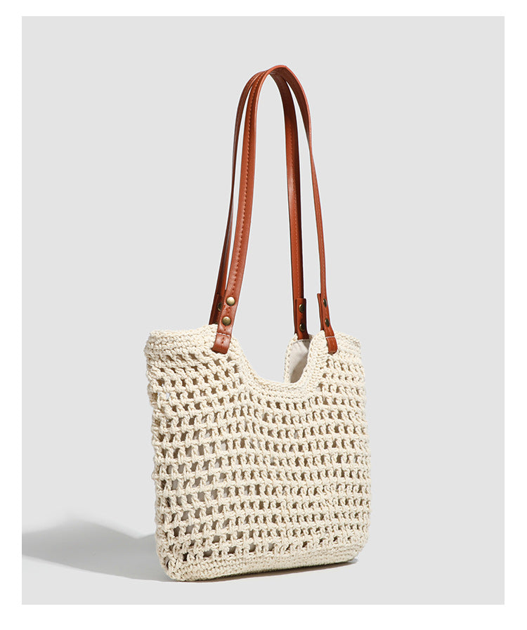 Open-knit woven tote bag with leather-look shoulder straps and brass-tone hardware in off-white, detail view 11
