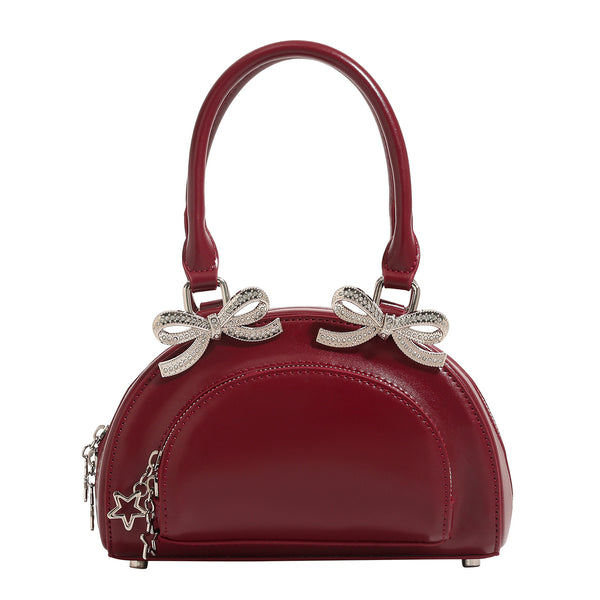 Structured half-moon mini handbag with silver-tone crystal bow hardware and star charm chain, detail view 5