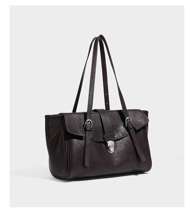 Large structured vintage-style tote bag with flap-front turn-lock closure, twin buckle straps, and double shoulder handles